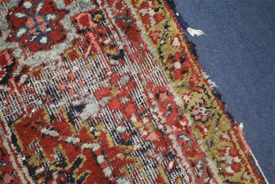 A Persian Heriz red ground carpet, 380 x 280cm, worn